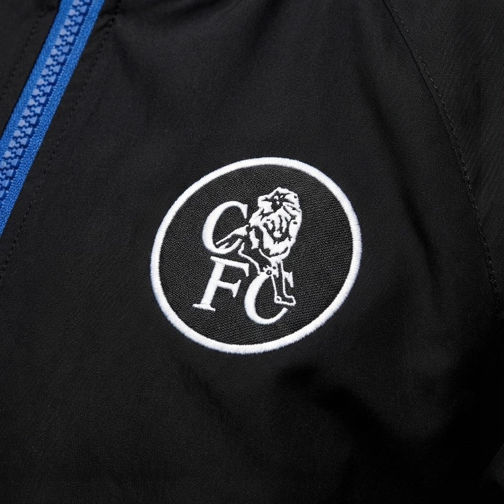 Close-up of a black jacket with a white logo featuring a lion and 'CFC' text.